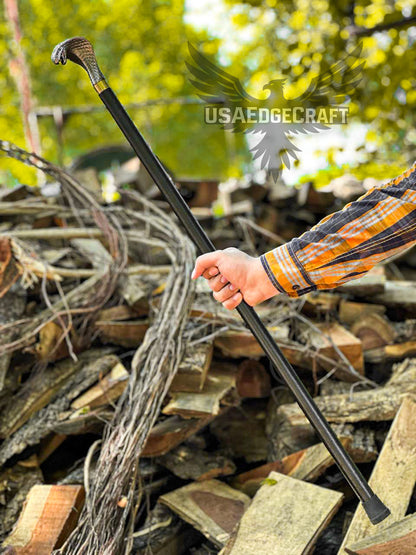 Detailed close-up of handcrafted antique silver snake head handle sword cane