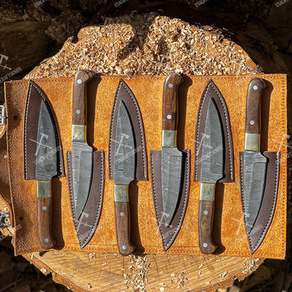 Set of knives in sheaths on a wooden display